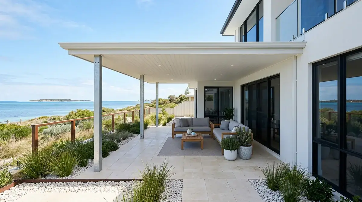 A marine-grade flat Colorbond patio on a Coogee block, low horizontal roofline with dune and the sheltered water of Cockburn Sound beyond.