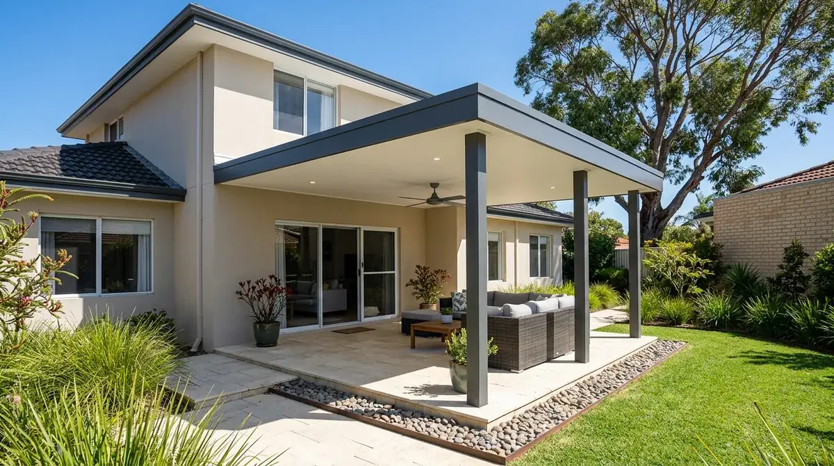 A Colorbond flat roof patio at the rear of a rendered two storey home in Joondalup, the flat roofline running level under the existing eave above a paved alfresco