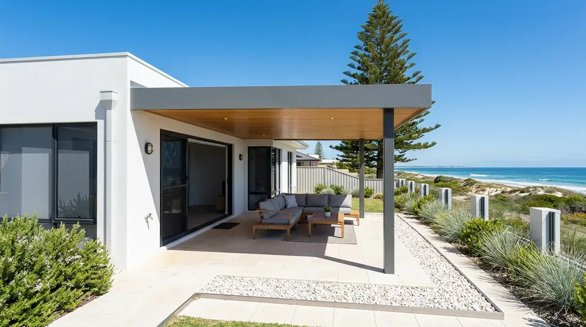 A flat roof patio behind a Scarborough home within sight of the coast, the low flat roofline in marine-grade Colorbond over a paved entertaining area