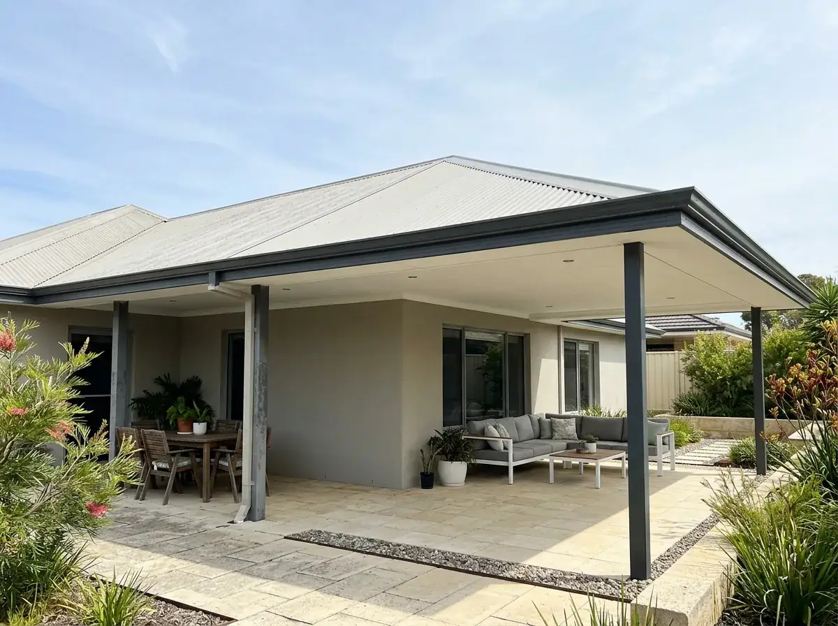 An extended flat roof patio on an established Perth home, the join visible partway along the roof where the newer section was added onto the original, the fascia running level through it with no step